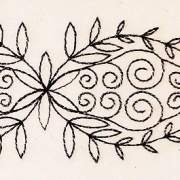 Artist trading card featuring a fish embroidered in black on cream background
