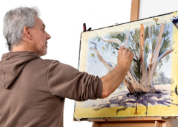 Greg Allen watercolour demonstration. Greg painting a white eucalypt tree at an easel.